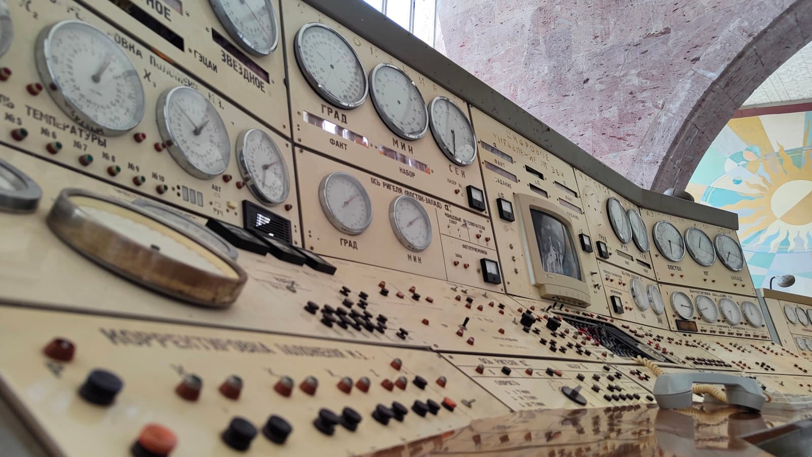 Rows of analog dials and switches on a vintage control panel