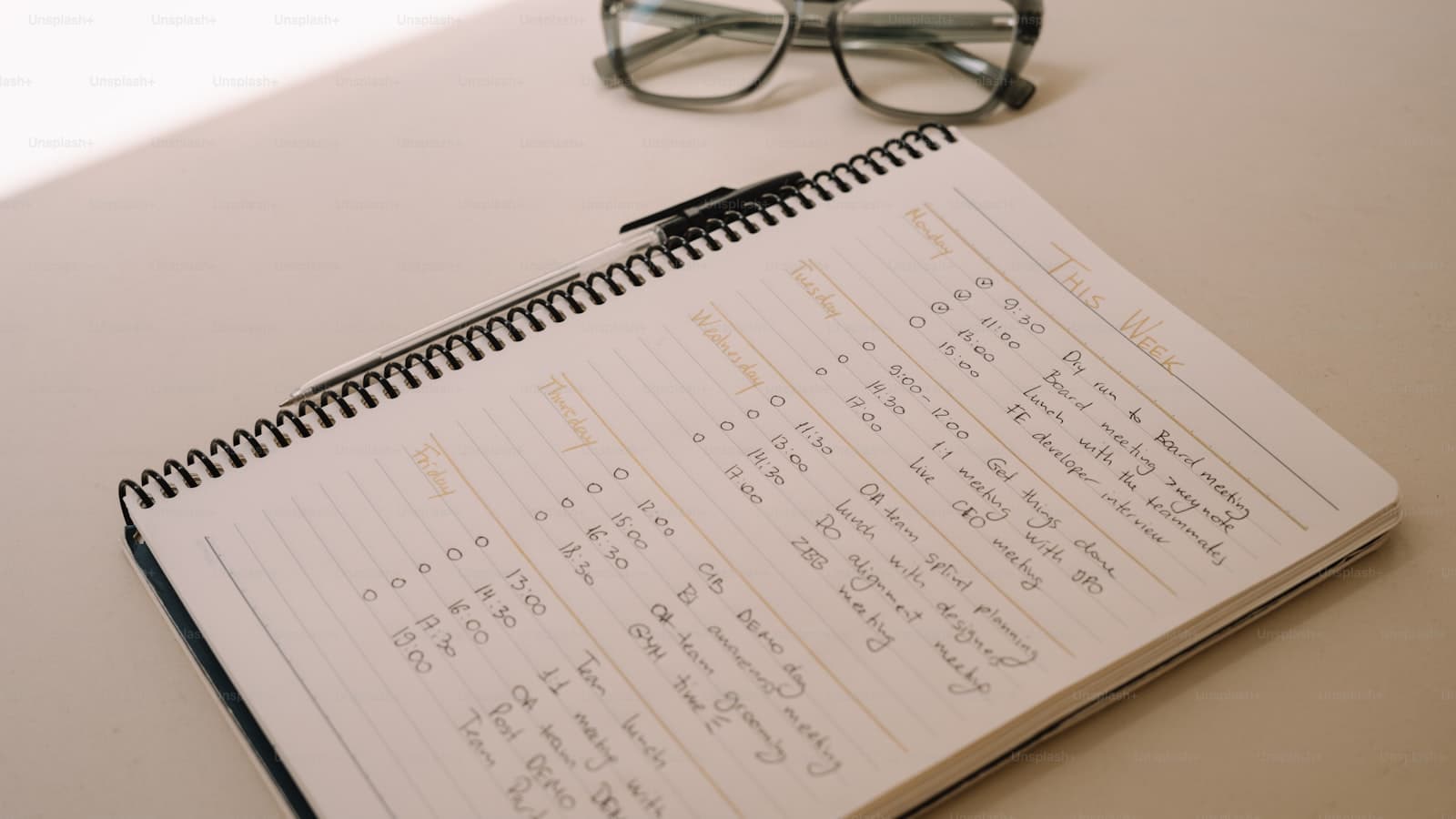 A calendar and a pair of glasses on a tabletop